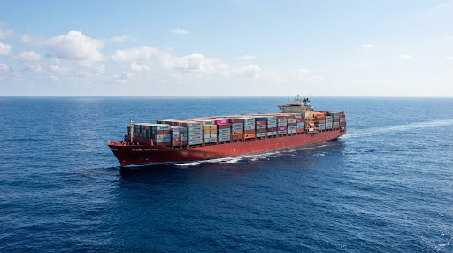 Commercial cargo and container ship navigating international sea route
